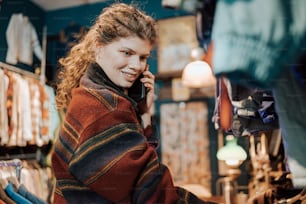 a woman talking on a cell phone in a store