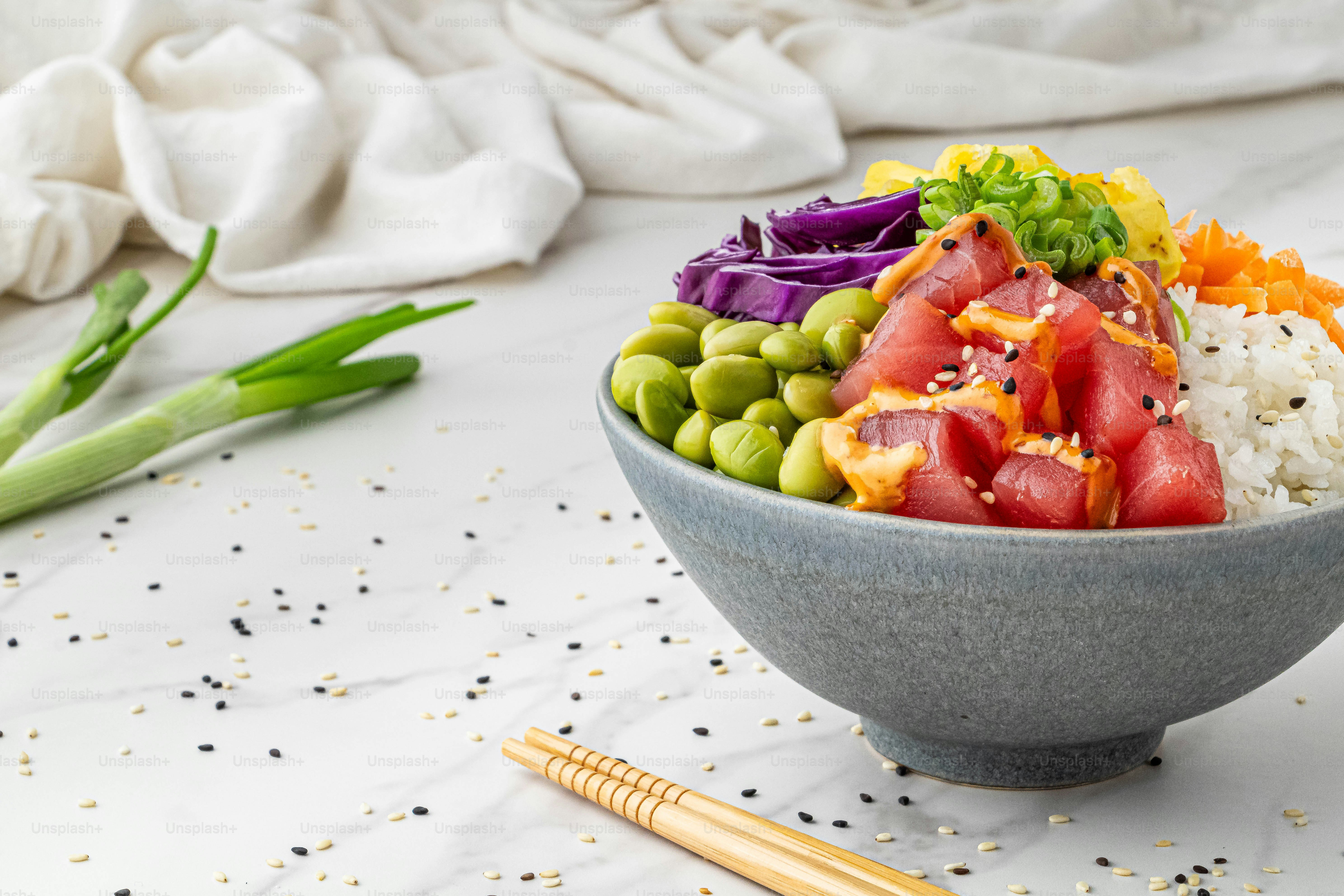 a bowl filled with rice and vegetables on top of a table