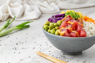 a bowl filled with rice and vegetables on top of a table