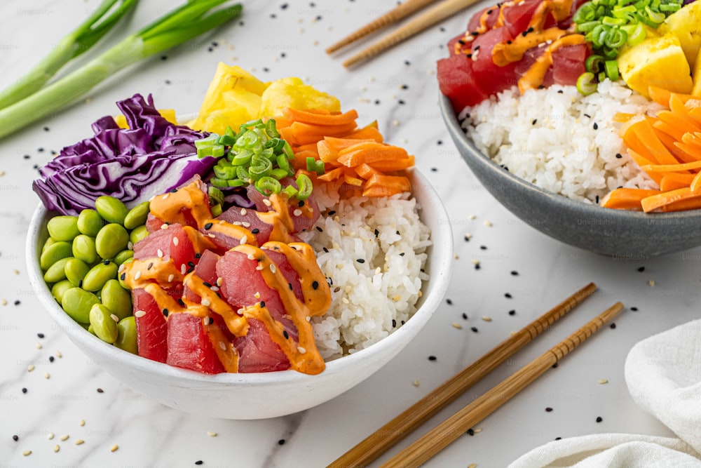 a bowl of rice, meat, and vegetables with chopsticks