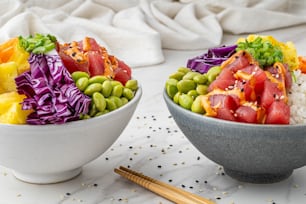 a couple of bowls filled with different types of food