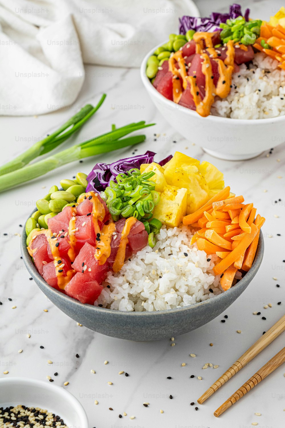 a bowl filled with rice, vegetables, and meat