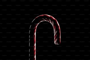 a candy cane is lit up in the dark