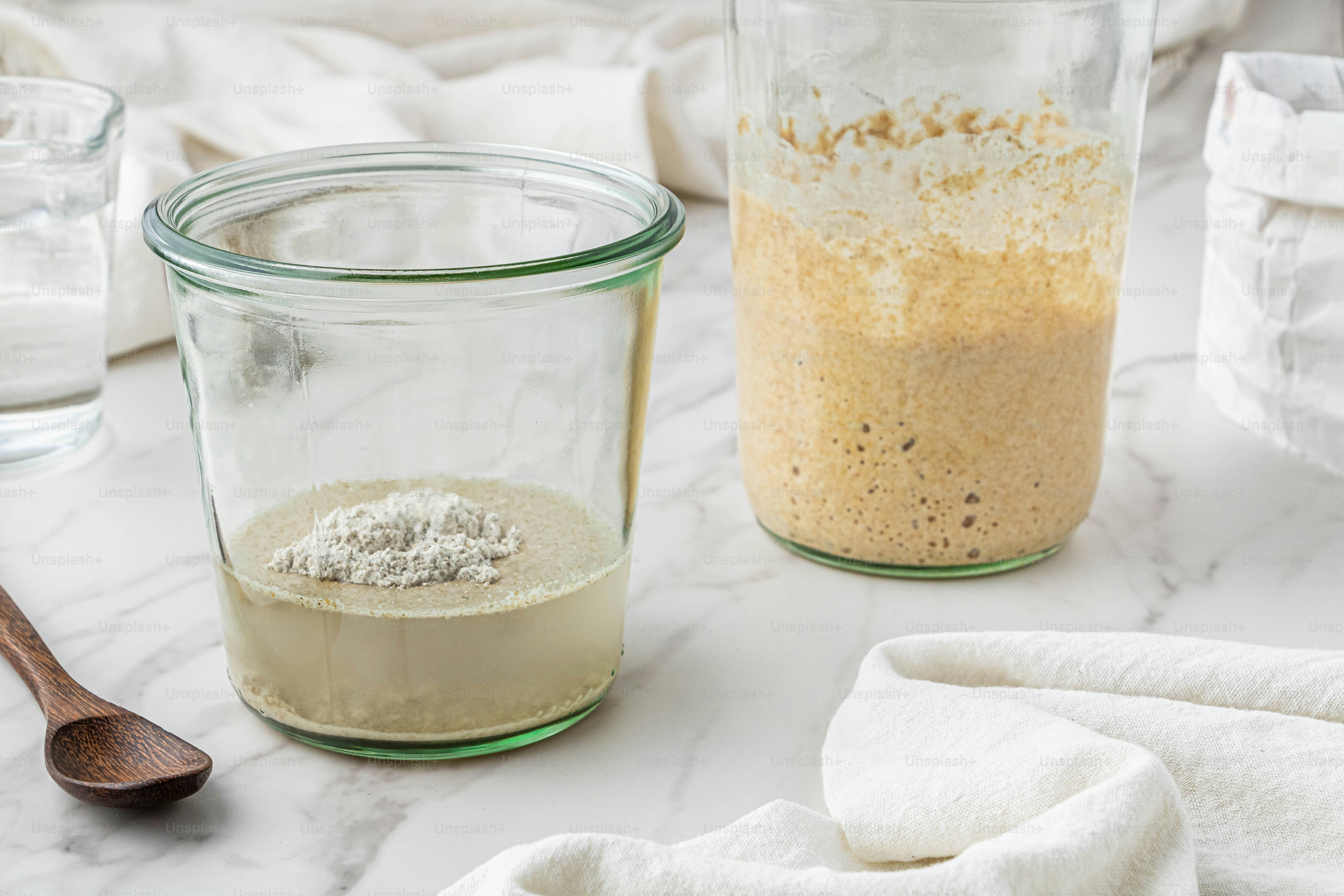 a couple of jars filled with food on top of a table