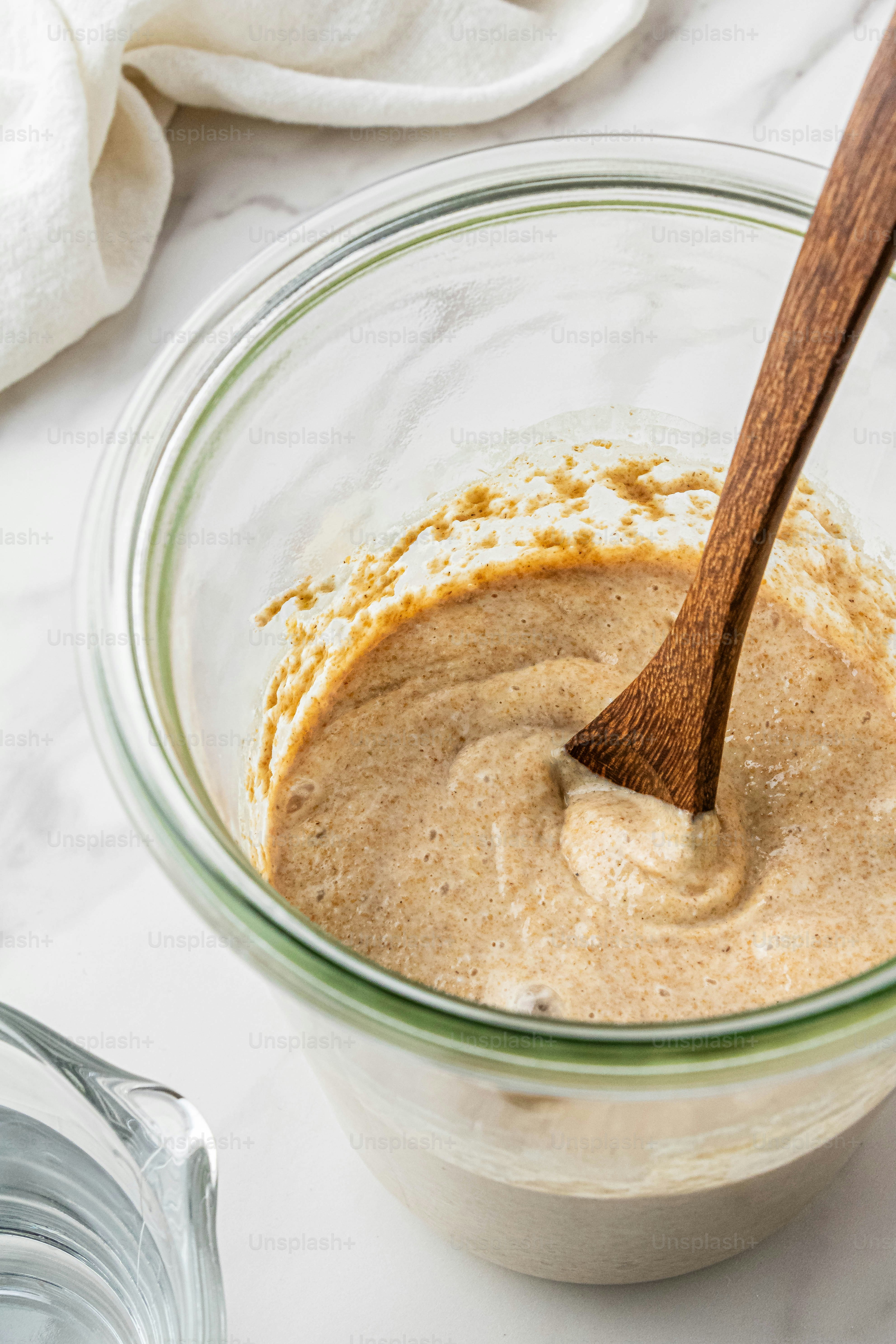 a wooden spoon in a bowl of food