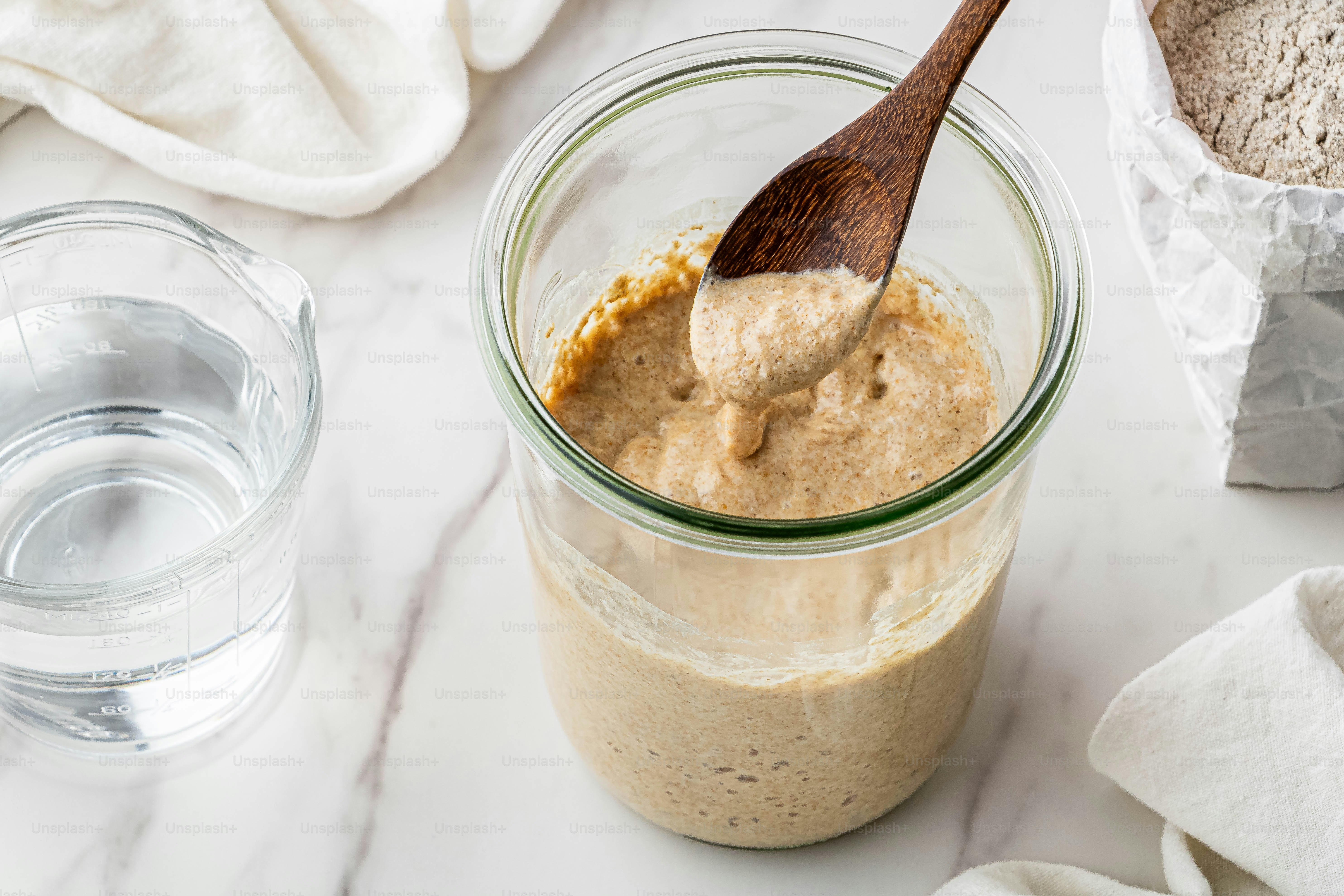 a wooden spoon is in a jar of peanut butter