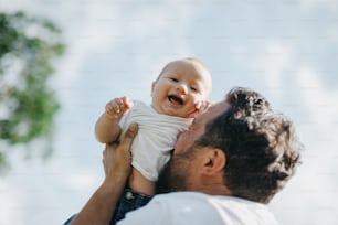 a man holding a baby up to his face