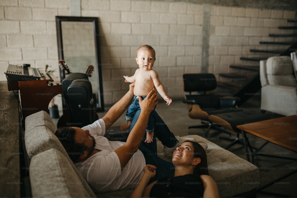 a woman holding a baby up in the air