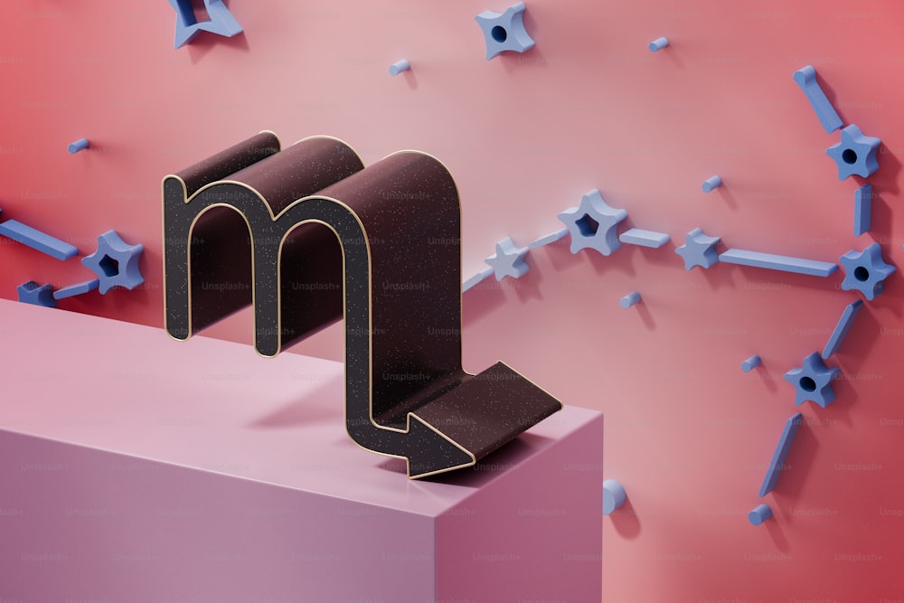 a pink and blue wall with a black letter m on it
