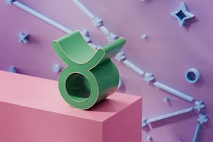 ein grünes Objekt, das auf einem rosa Block sitzt