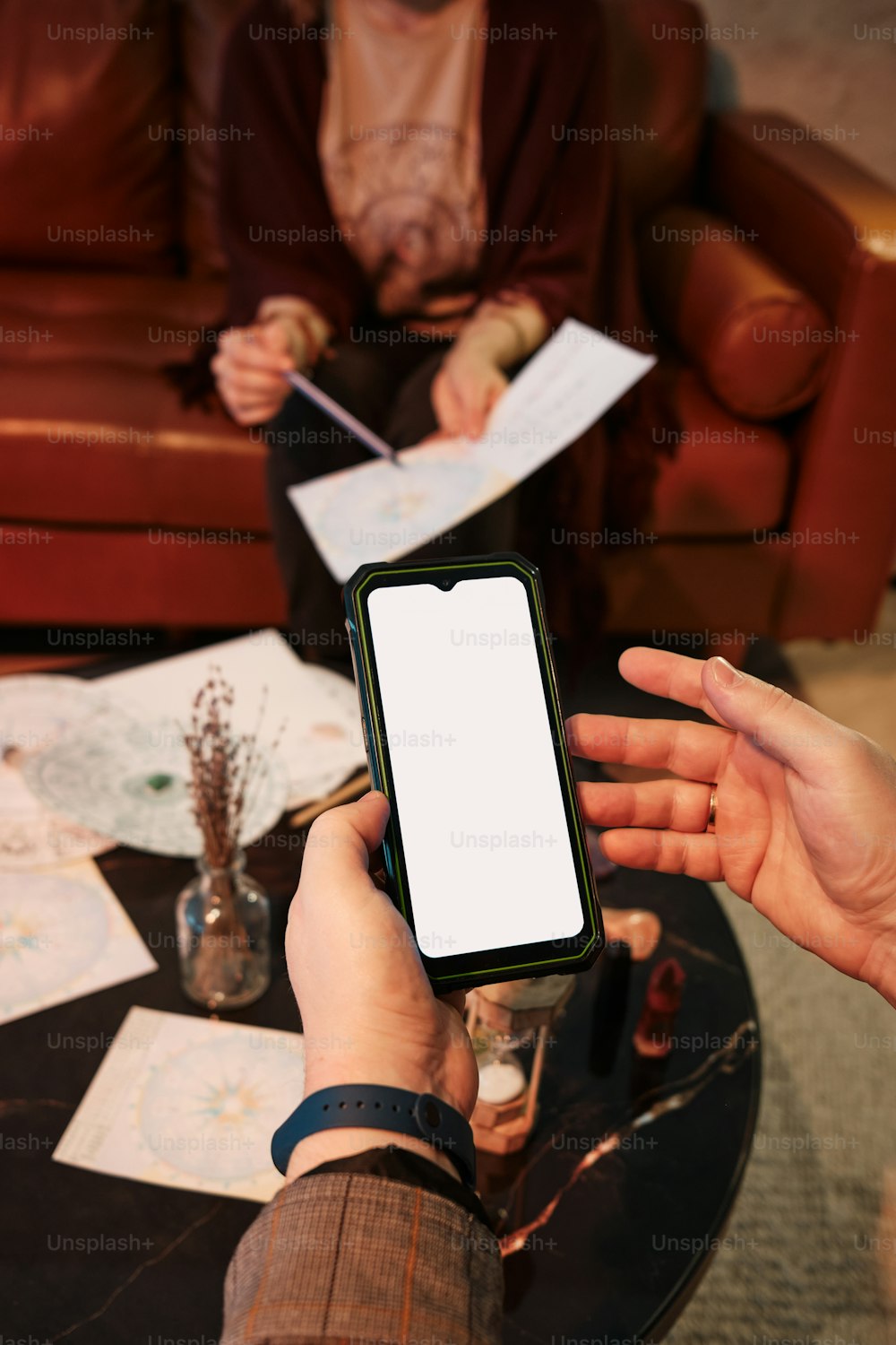 a person holding a cell phone in their hand