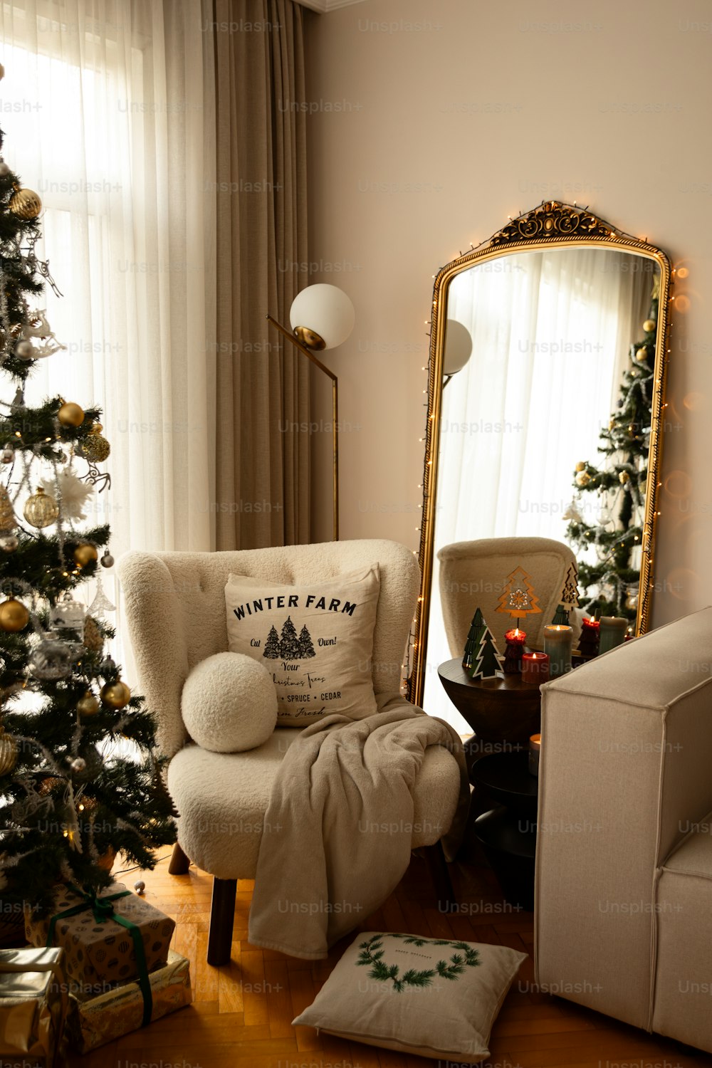 a living room with a christmas tree and a chair
