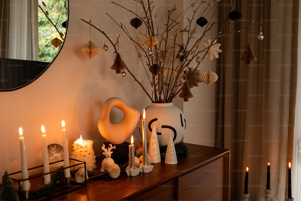 a table topped with a vase filled with lots of candles