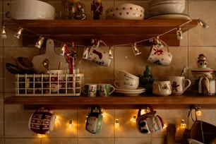 a shelf filled with dishes and cups on top of a tiled wall