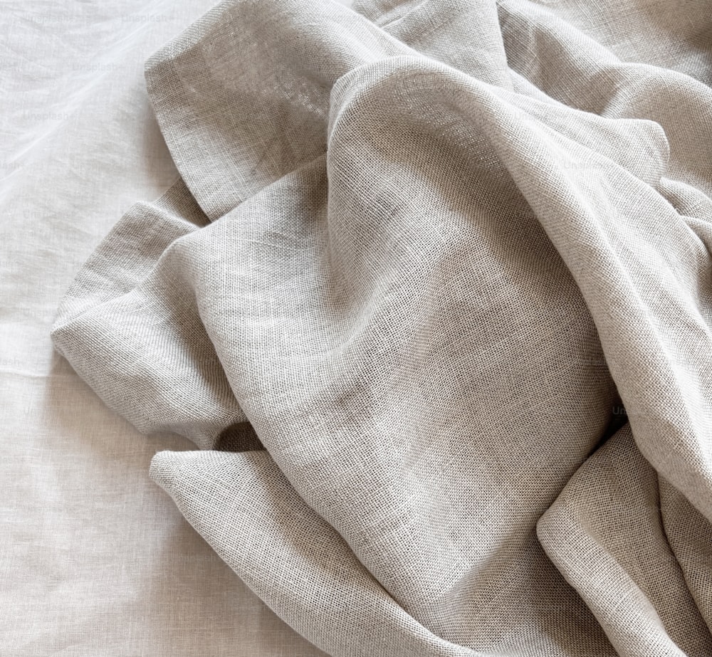 a close up of a bed with a white comforter