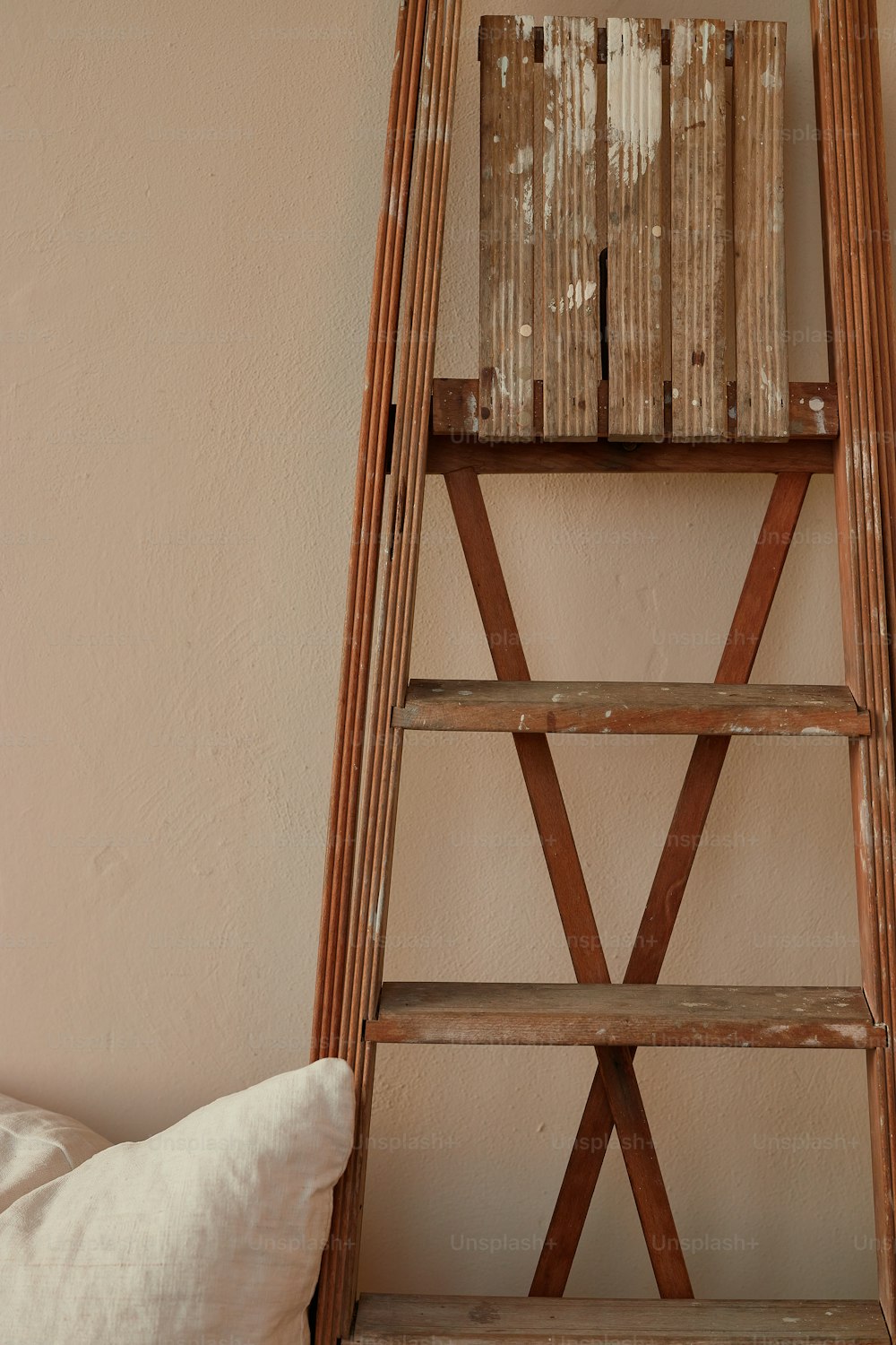 a wooden ladder leaning against a wall