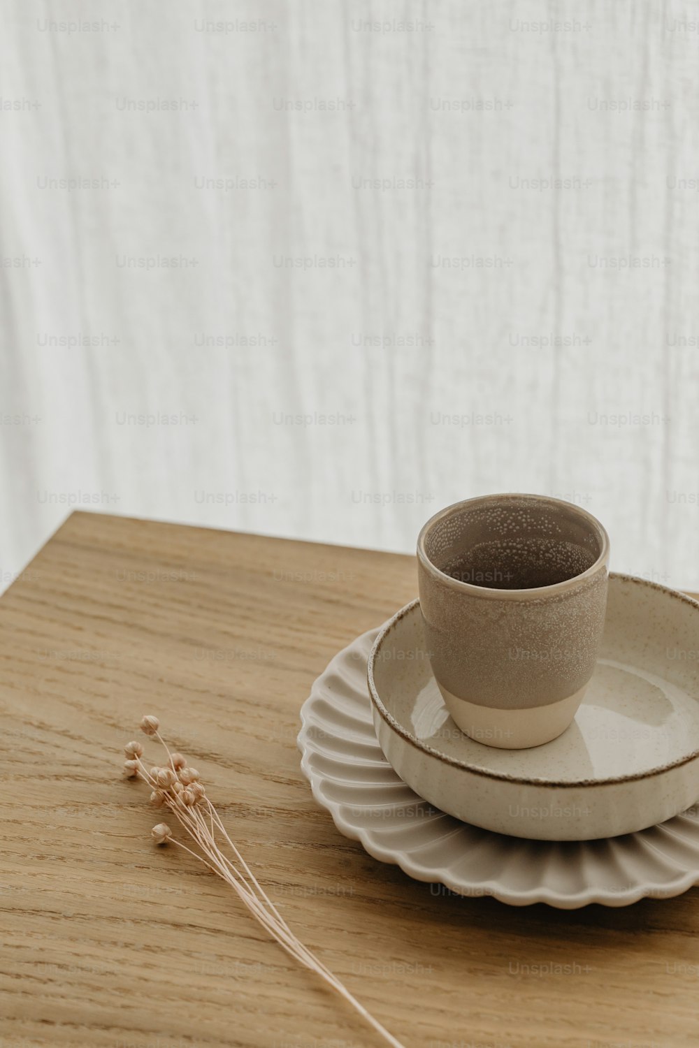 a cup and saucer sitting on top of a wooden table