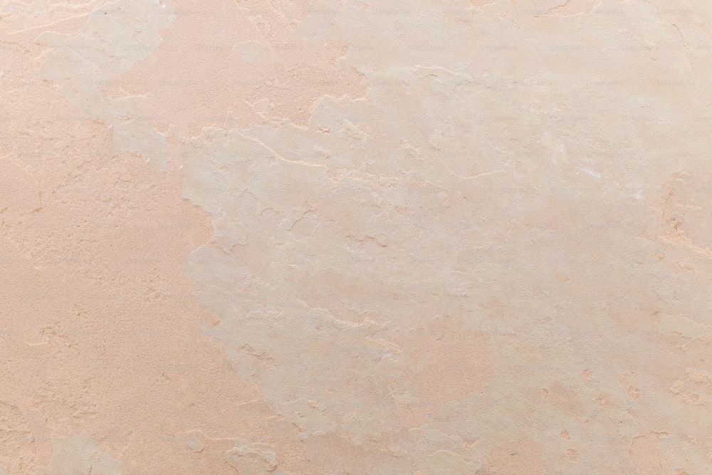 a close up of a pink marble wall