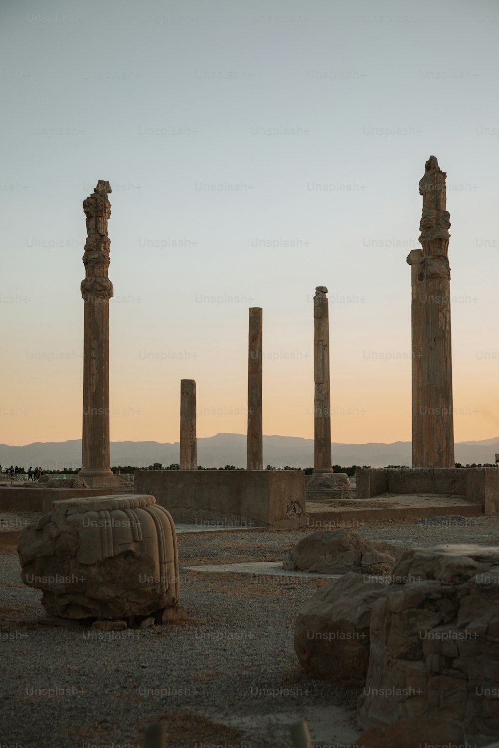 a group of stone pillars sitting in the middle of a desert