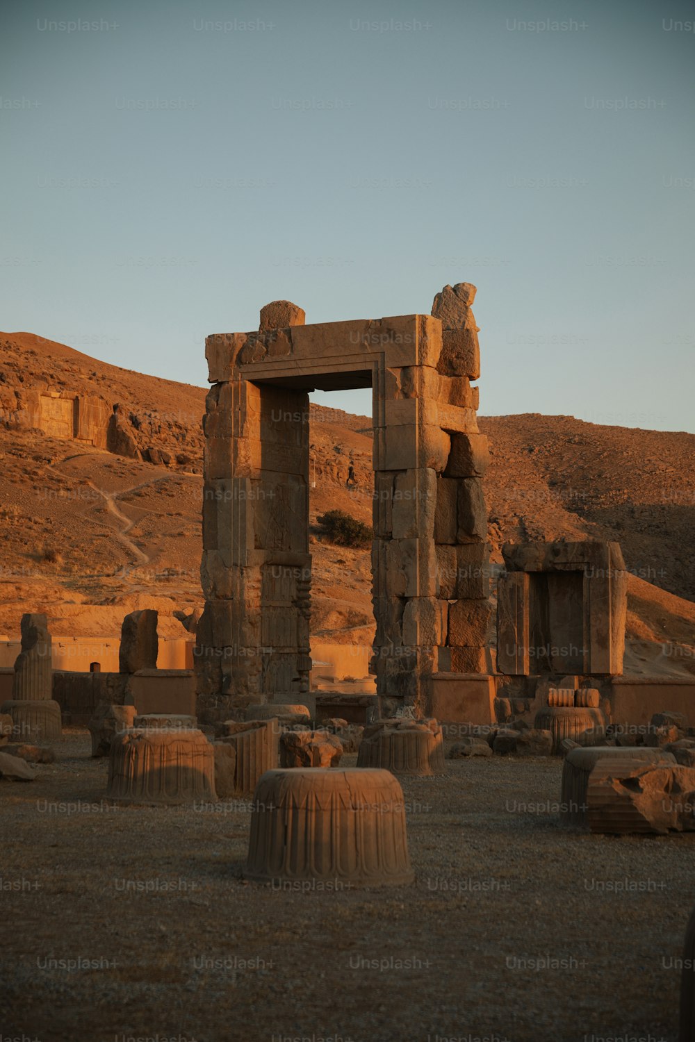 a stone structure in the middle of a desert