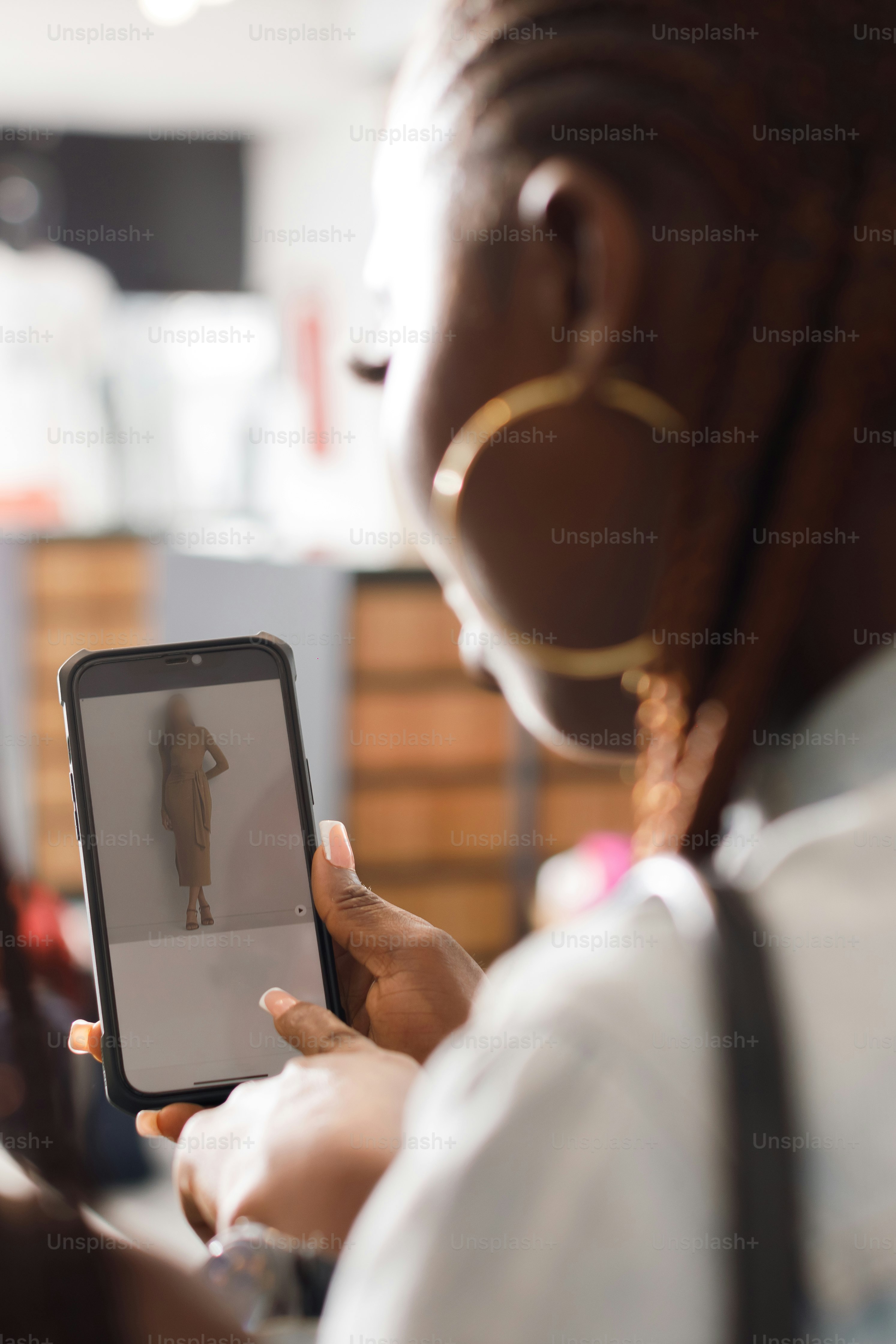 a woman holding a cell phone in her hand