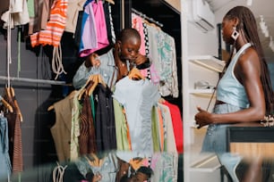 a woman looking at a shirt in a clothing store