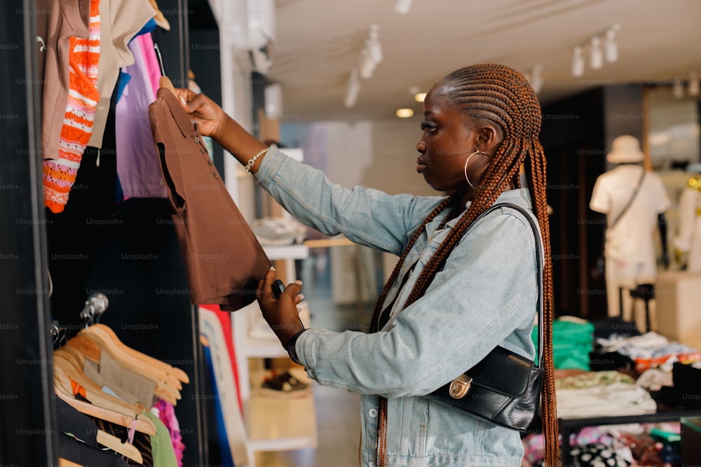 a woman looking at clothes hanging on a rack