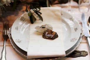 a place setting with silverware and flowers