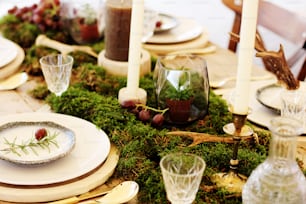 a table is set with plates and candles