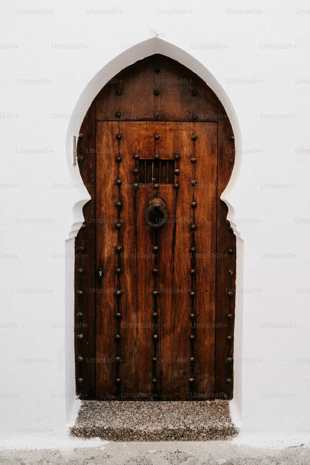 a wooden door with a white wall behind it