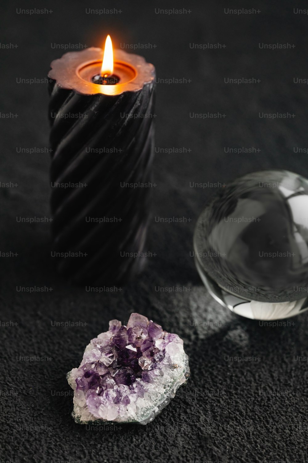 a candle that is next to a rock