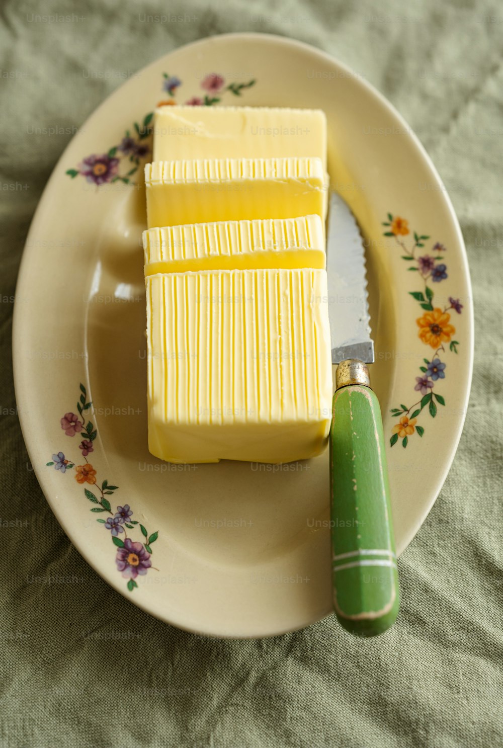 a piece of yellow cake on a plate with a knife