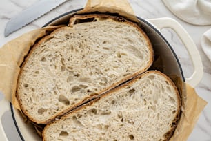 ein Laib Brot in einer Pfanne mit einem Messer