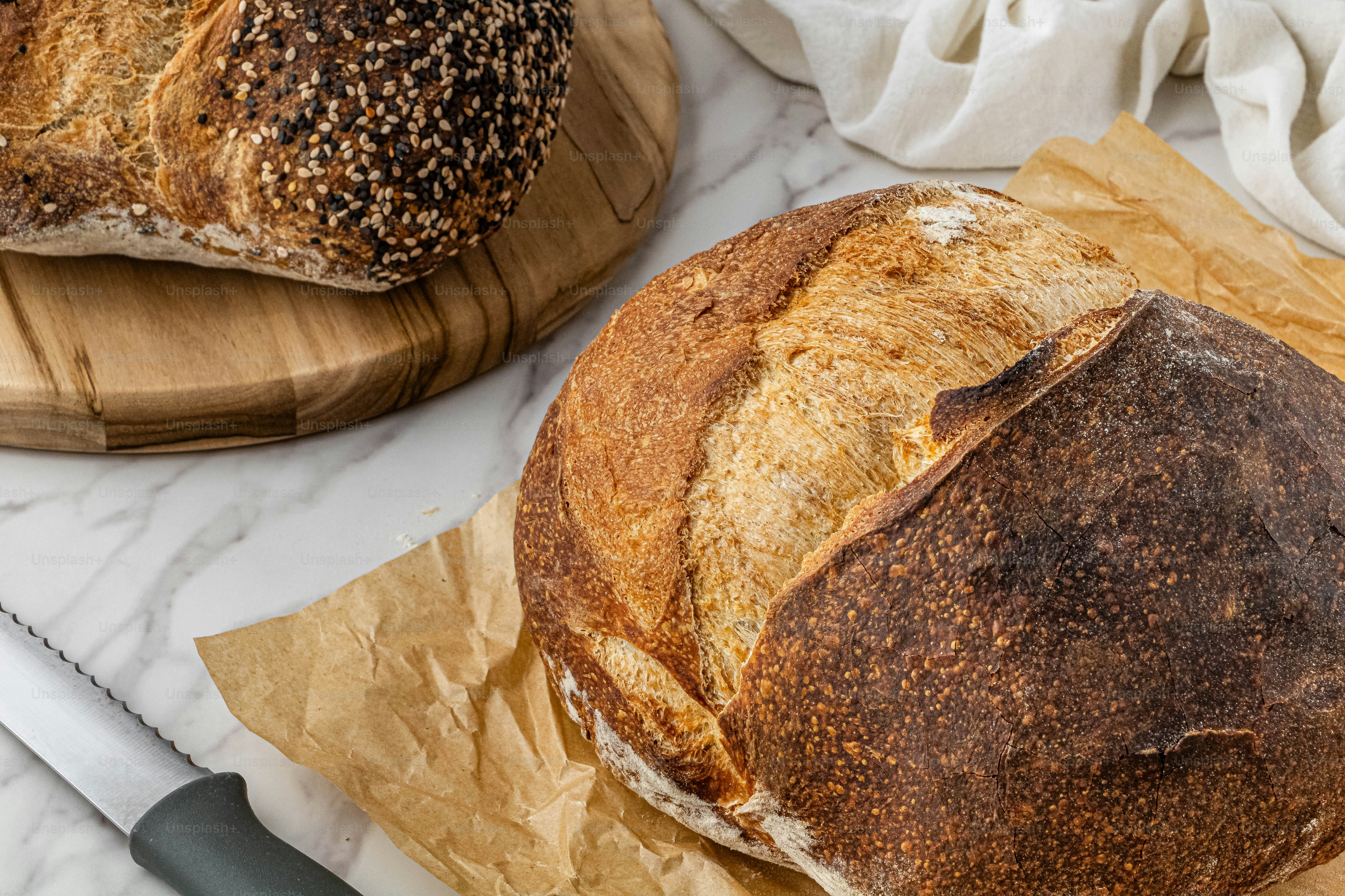 a loaf of bread sitting on top of a wooden cutting board
