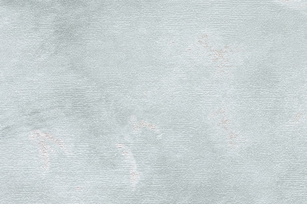 a textured paper background with a faded design