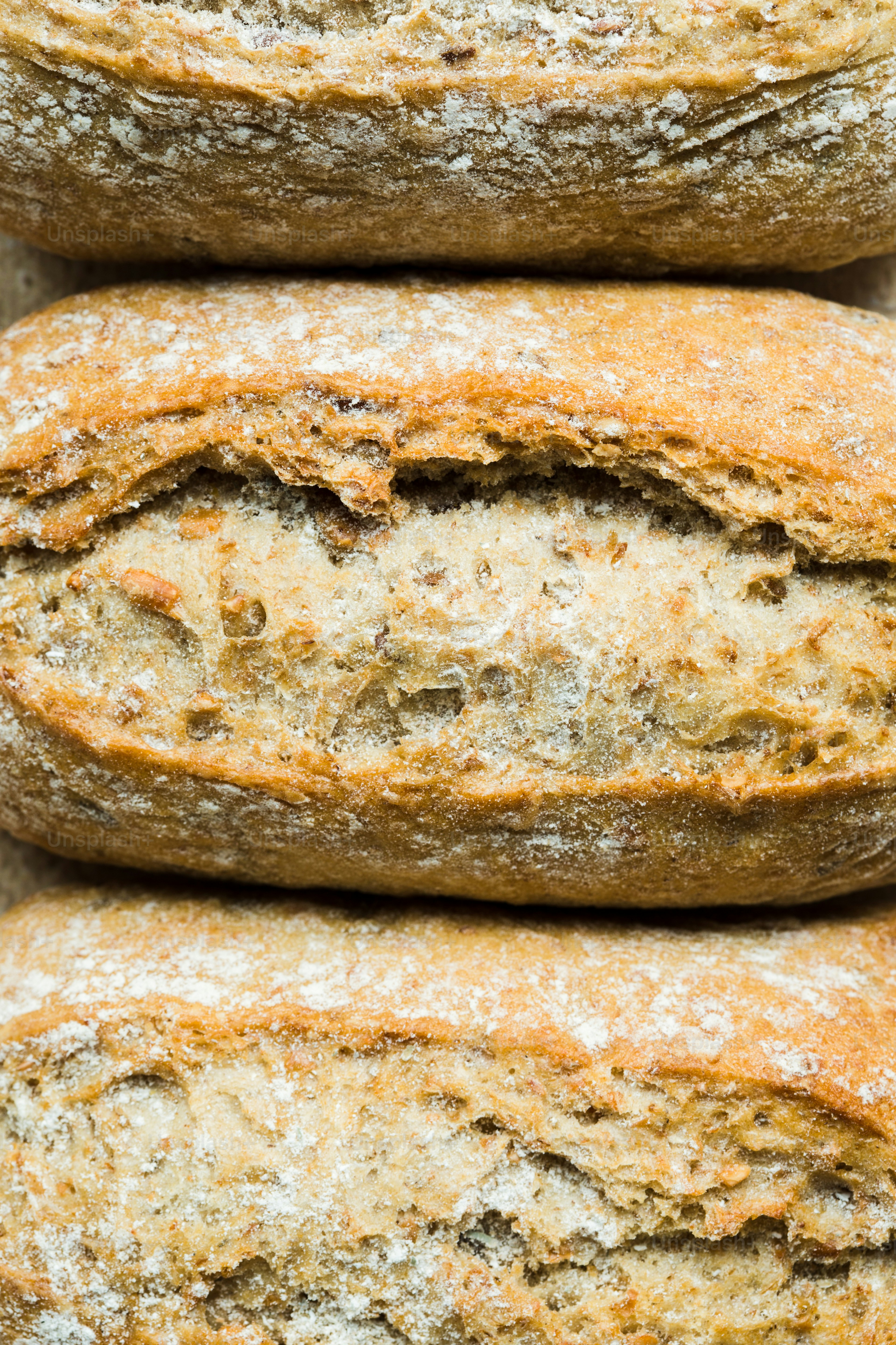 a close up of three loaves of bread