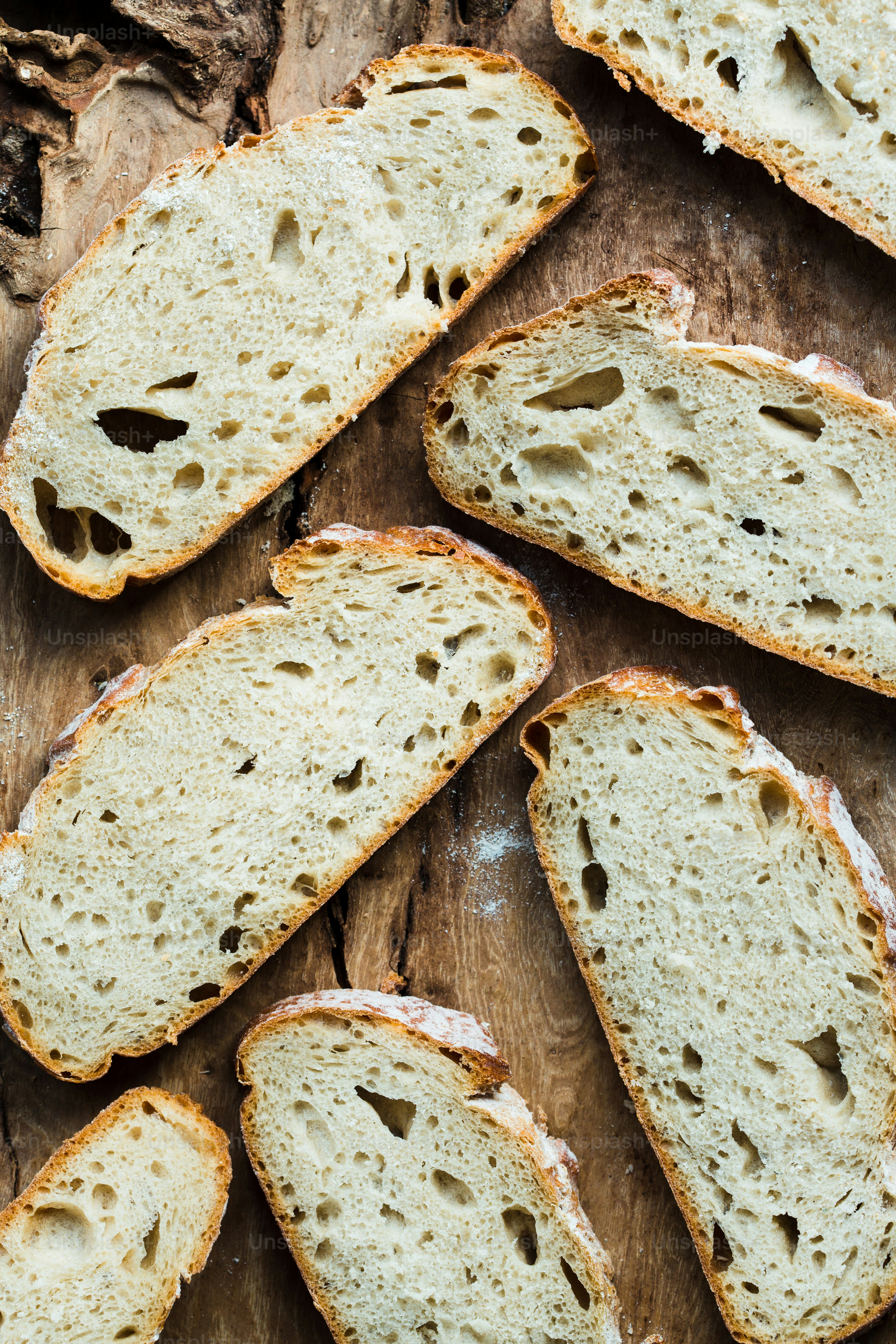 a close up of sliced bread on a wooden surface