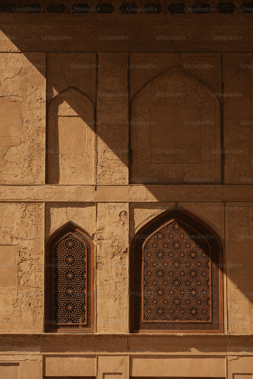 the shadow of two windows on the side of a building