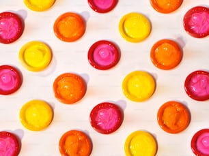 a close up of many different colored candies