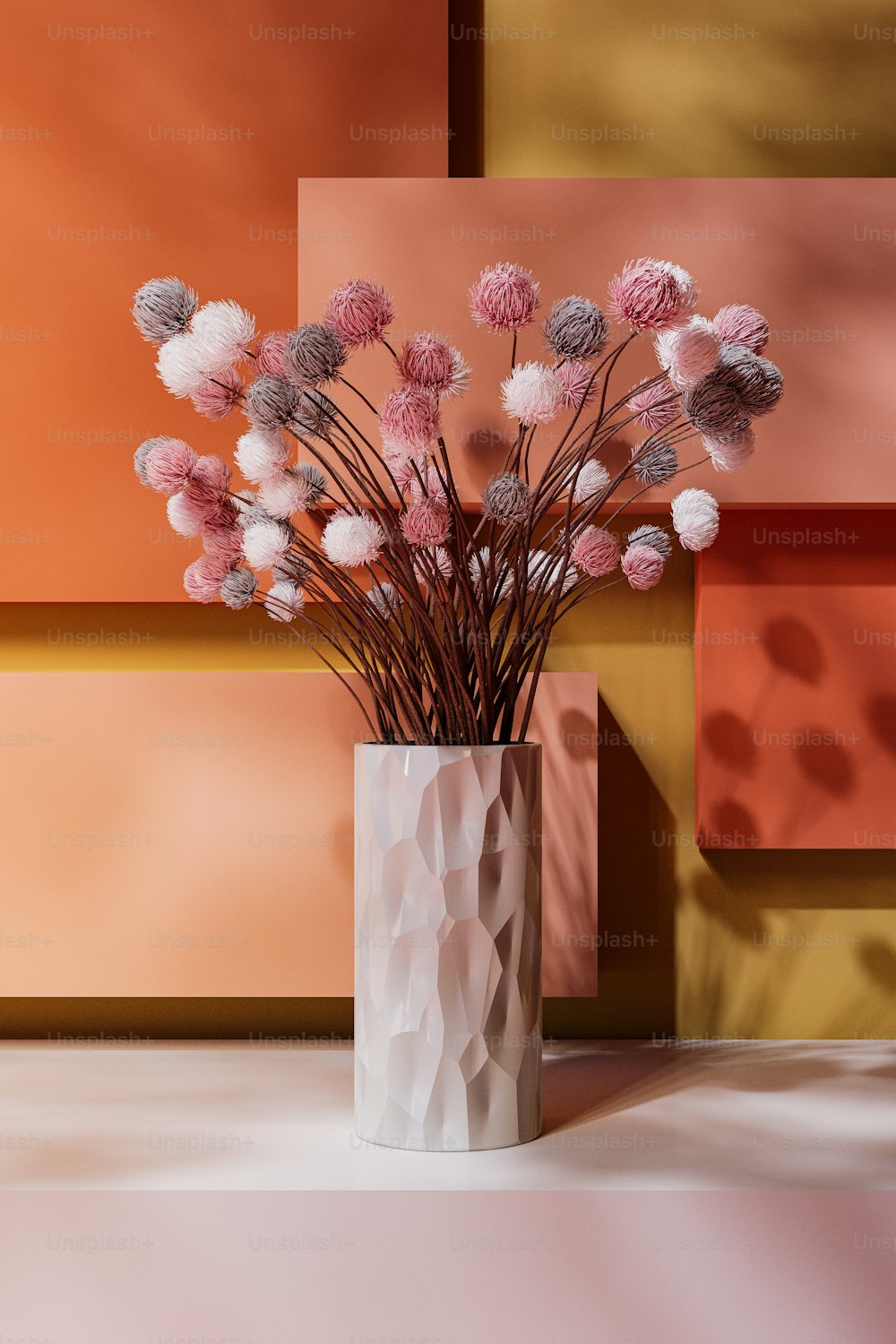 a white vase filled with pink and white flowers