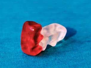 a red and white toothbrush sitting on top of a blue surface