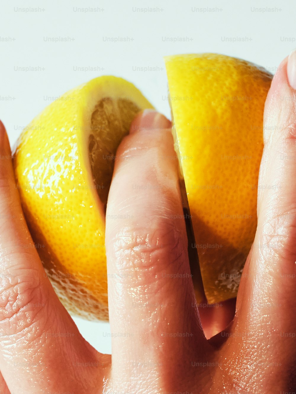 a close up of a person holding an orange