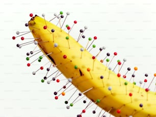 a banana with a bunch of pins on it