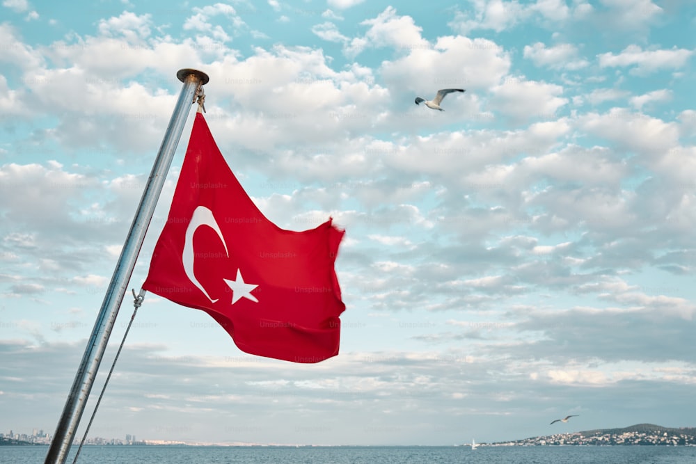a turkish flag flying in the wind on a boat