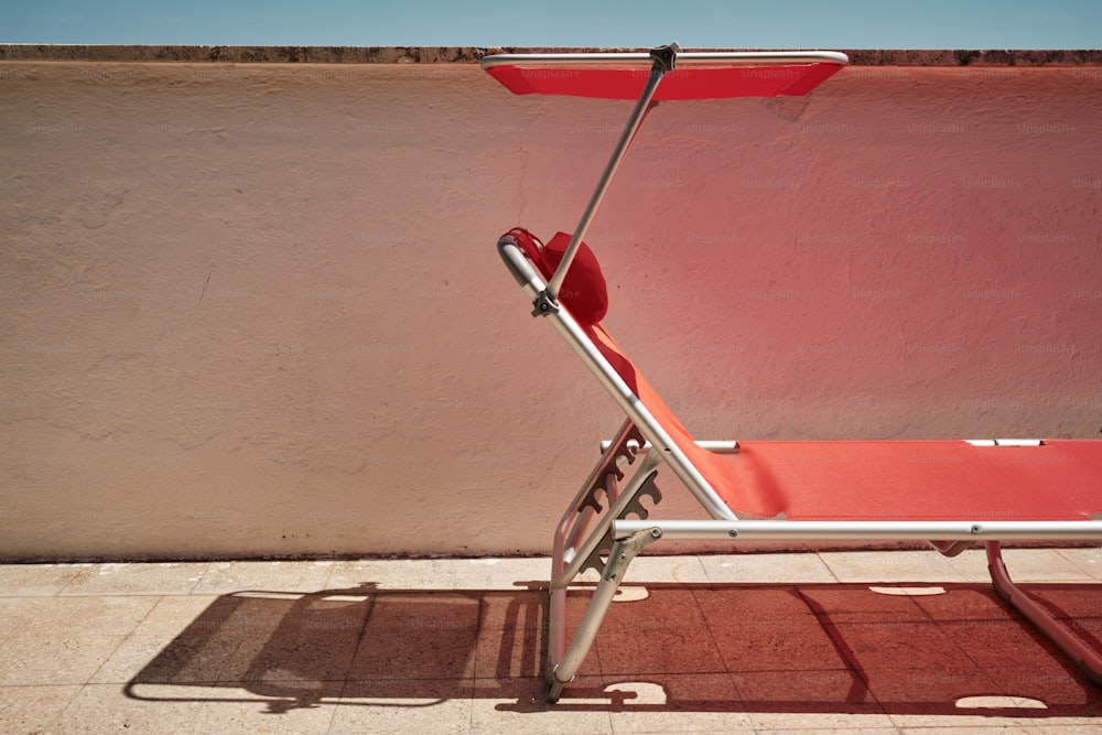 a red chair sitting on top of a tiled floor