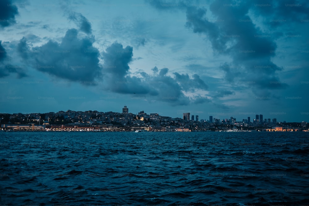 a large body of water with a city in the background