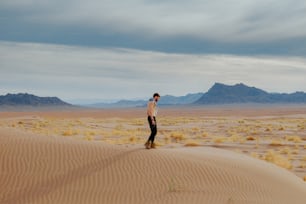 a man standing in the middle of a desert