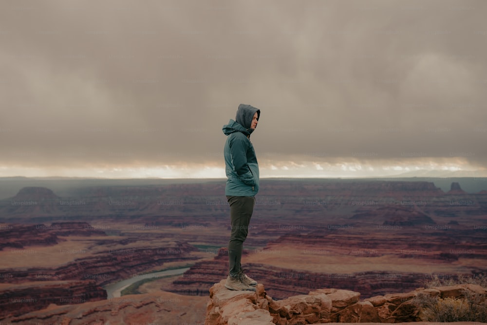 a man standing on top of a large cliff