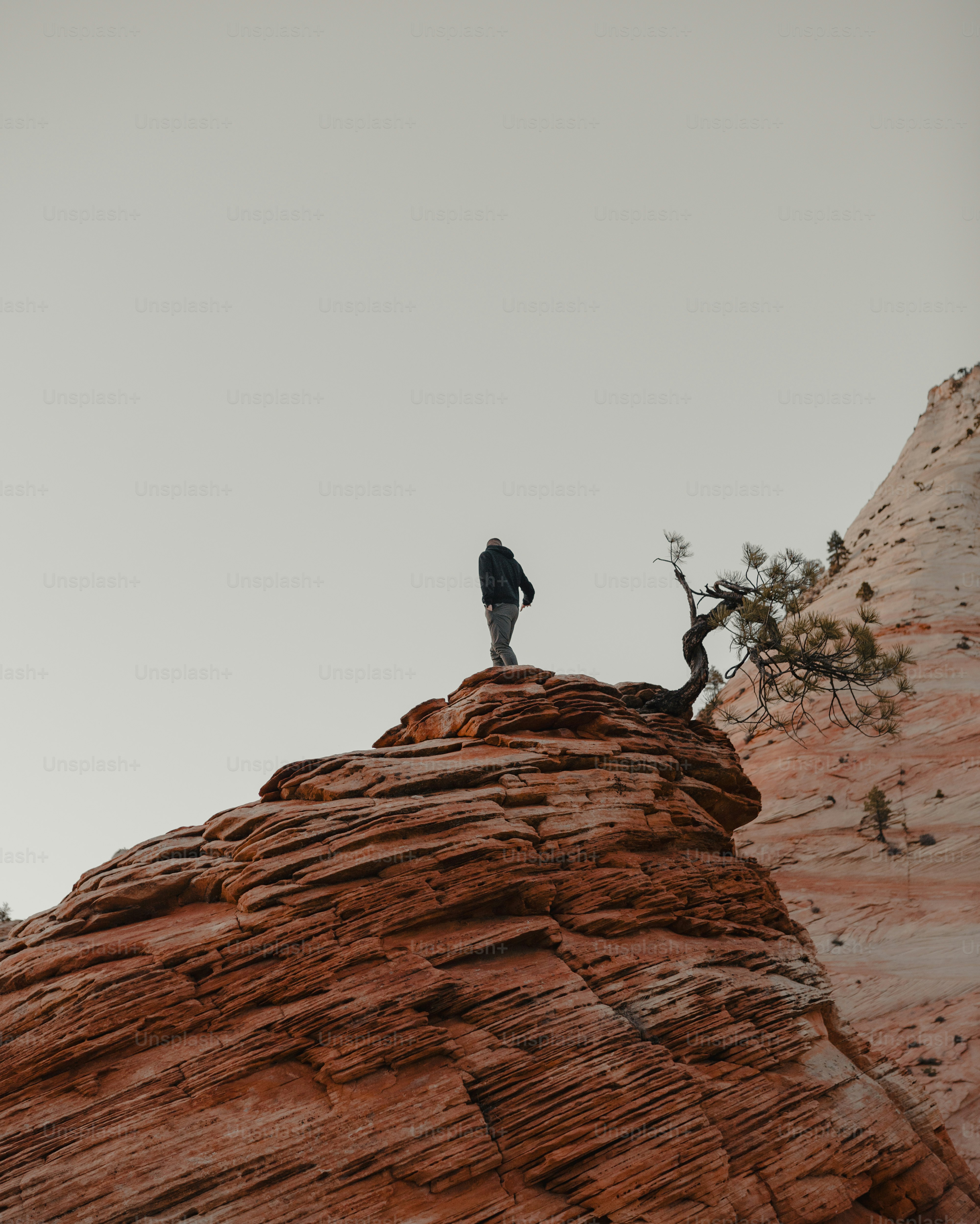 a person standing on top of a large rock