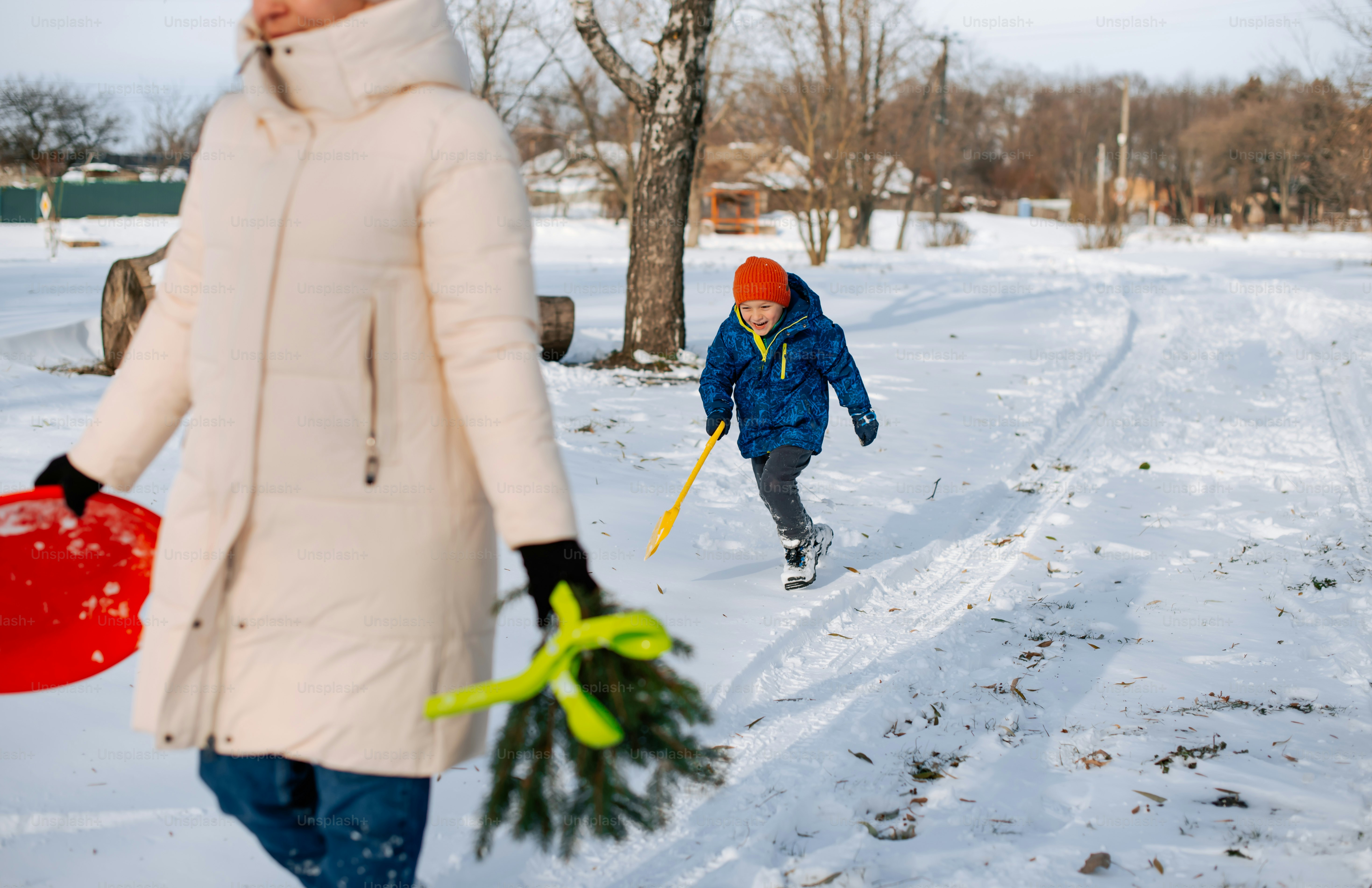 a woman and a child walking in the snow